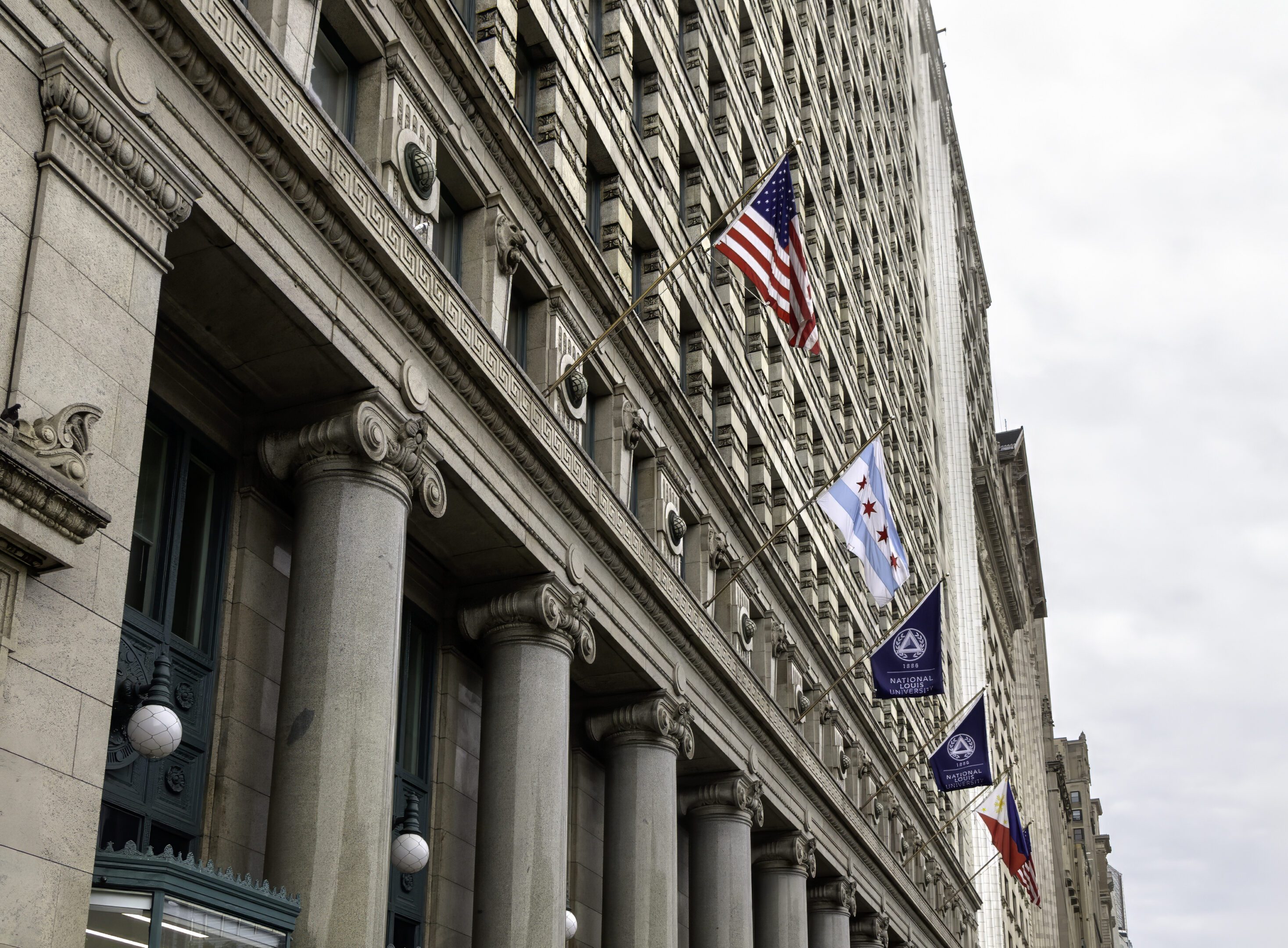 Flags of the USA, Chicago, and National Louis University on downtown campus building
