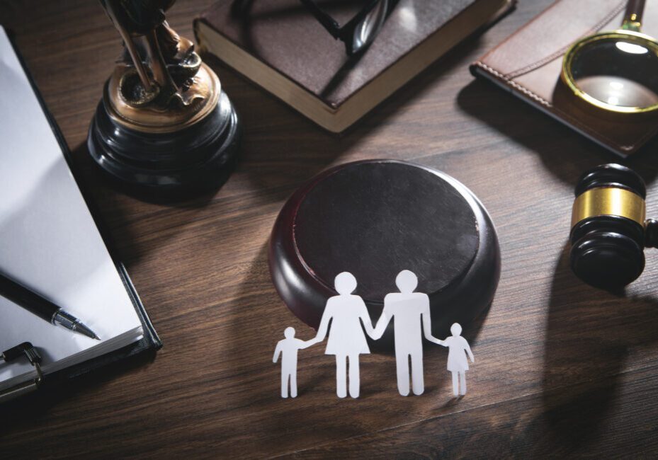 Paper cut family, judge gavel, book and other objects. Family Law
